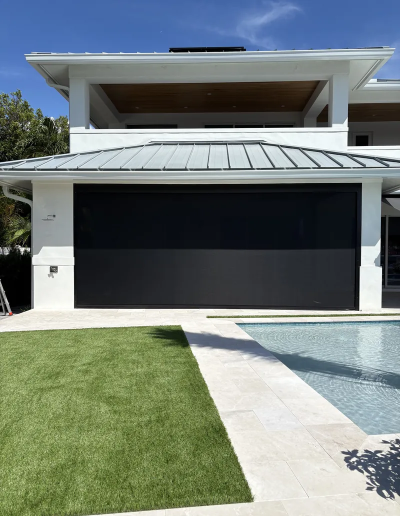 Modern House with Large Motorized Screen Overlooking Pool and Lawn Area