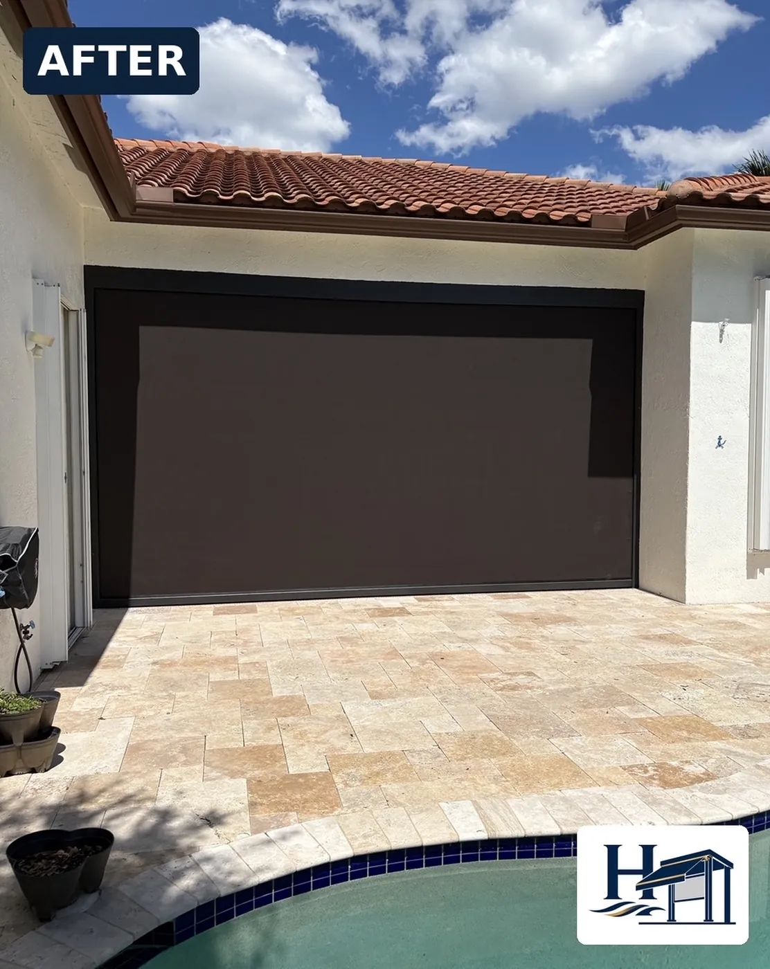 Patio with Motorized Retractable Awning and Tile Flooring Under a Clear Sky